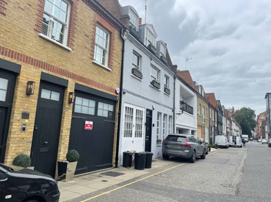 Pavilion Road, London before — a service lane of garages and parked cars
